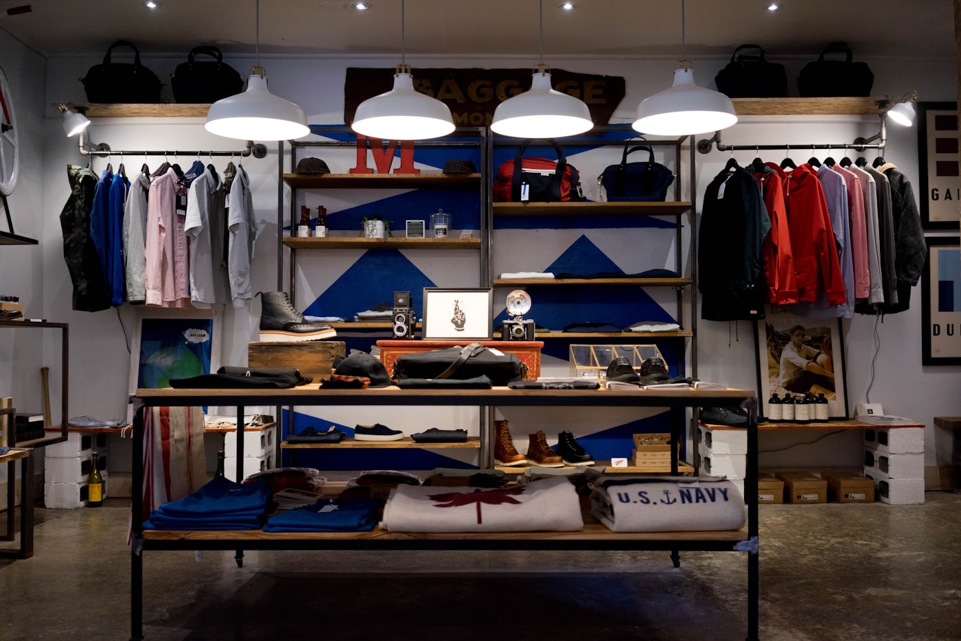Clothing and accessories laid out on a display table in a menswear shop